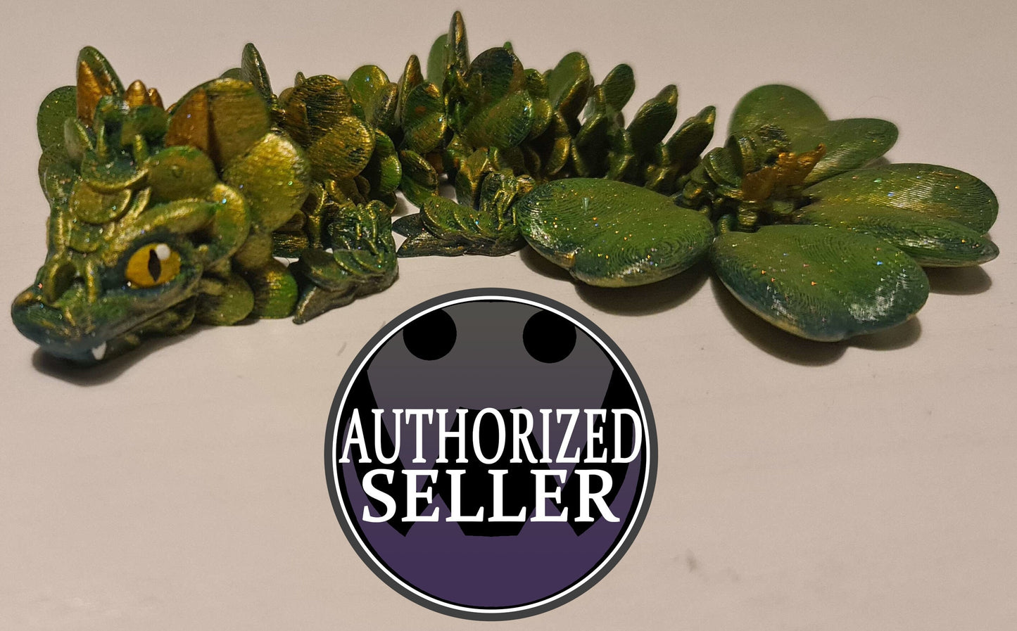 Green dragon figurine with leafy scales and yellow eyes, AUTHORIZED SELLER badge in front.