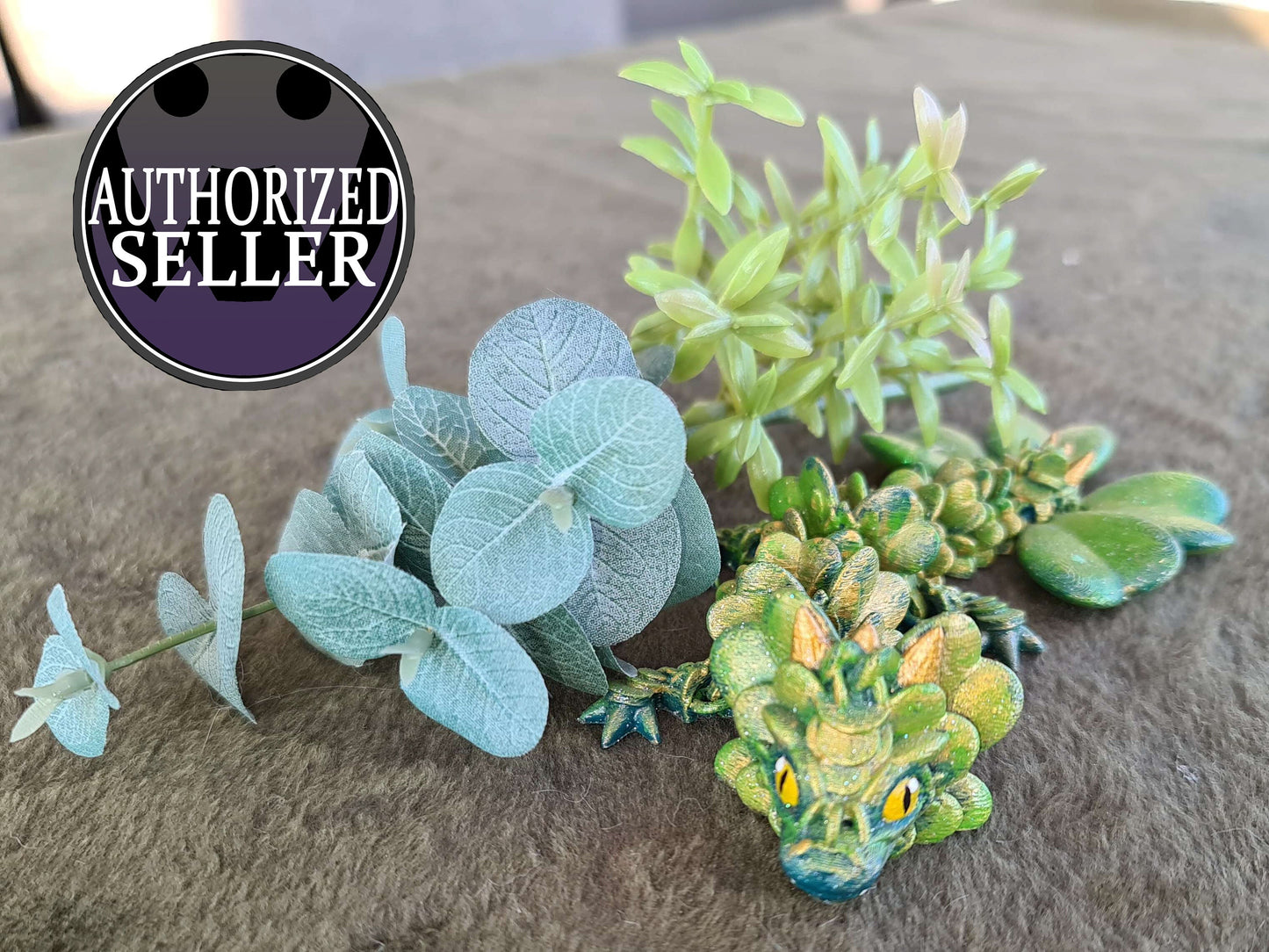 Green dragon figurine with artificial plants, authorized seller badge, tabletop display