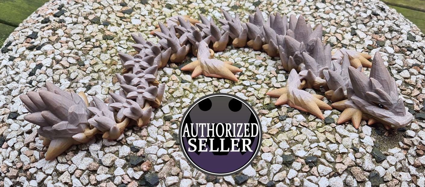 3D printed segmented dragon toy on gravel, AUTHORIZED SELLER badge in foreground